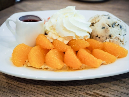 Orange Crepe cake on the table is a delicious cake.の写真素材