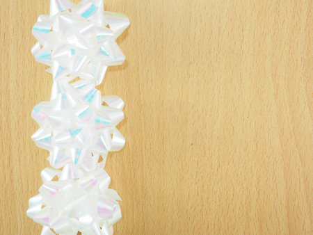 a wooden frame decorating with white-pearl color bows.