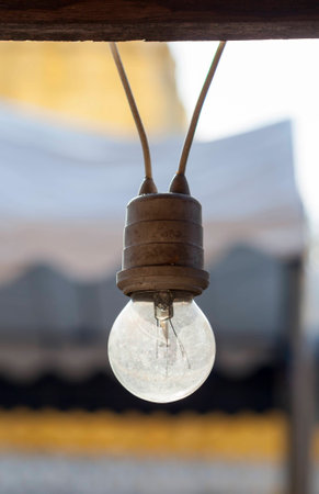 A bulb hanging on the electric wiresの写真素材
