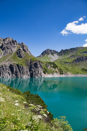 Beautiful unspoilt nature with clear green water and mountains in the backgroundの写真素材
