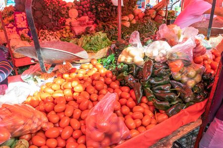 Woman buying some vegetables and fruits in a local mexican marketの写真素材