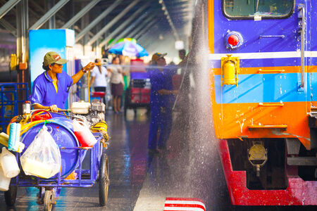 Worker cleaning the train at station Thailand のeditorial素材