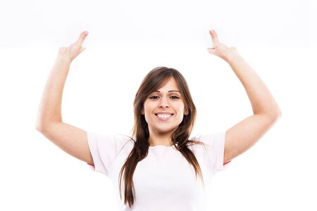 Portrait of a young woman with blank billboard isolated on white backgroundの写真素材