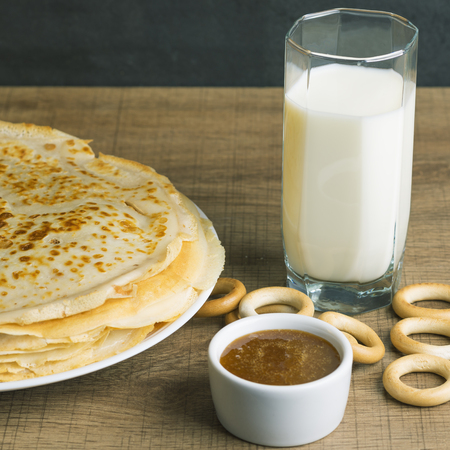 Breakfast milk with pancakes and honey.の写真素材