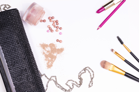 Composition of the clutch and cosmetics on a white backgroundの写真素材