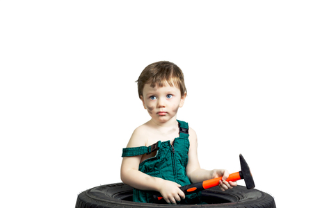 Little boy in a green suit with the tools and the wheelの写真素材