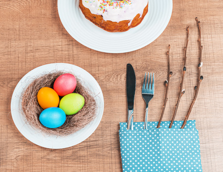 Festive table with colorful Easter eggs and  cupcakeの写真素材