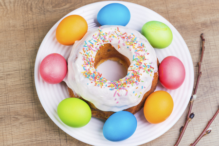 Festive table with colorful Easter eggs and  cupcakeの写真素材