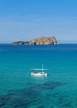 Seascape with boat in front of the island of Ibizaの写真素材