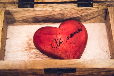 Ti amo, I love you in Italian language. Red heart on wooden background