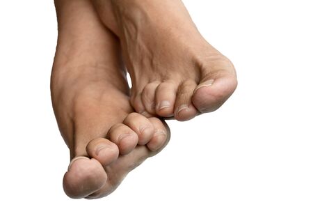 Feet of a caucasian adult woman on white background.