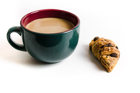 Cup of green latte coffee and croissant on the table. Breakfast