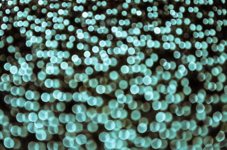 Blue bokeh, abstract background with defocused glittering lightsの写真素材