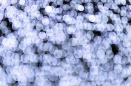 Blue bokeh, abstract background with defocused sparkling lightsの写真素材