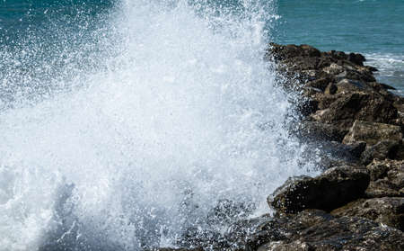 Close-up of sea waves breaking on the rocks of Vilanova y la Geltru beachの写真素材