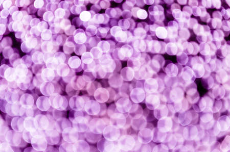 Vioilet bokeh, abstract background with defocused sparkling lightsの写真素材