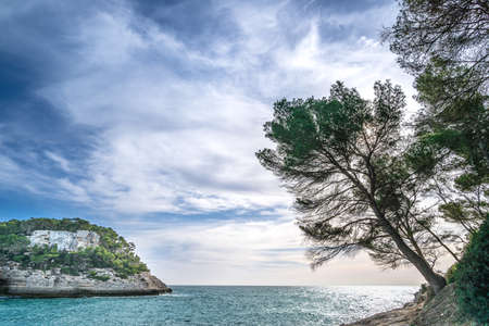 Beautiful views of the sea and the blue sky on the horizon from the Cala Mitjana de Ferrerias, Menorca, Spainの写真素材