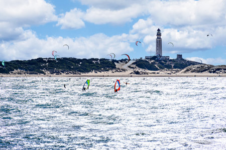 People practicing kitesurfing on the beach of Los CaÃ±os de Meca, next to the Trafalgar Lighthouse, Barbate, CÃ¡dizの写真素材