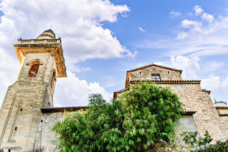 View of the bell tower of the San Bartolome church at dusk, from the picturesque village of Valldemosa, Mallorca, Balearic Islands, Spainの写真素材