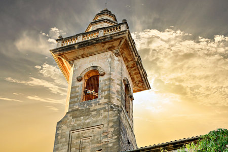 View of the bell tower of the San Bartolome church at dusk, from the picturesque village of Valldemosa, Mallorca, Balearic Islands, Spainの写真素材