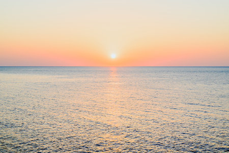 Beautiful sunset with orange sky on the beach of Menorca, Balearic Islands.の写真素材