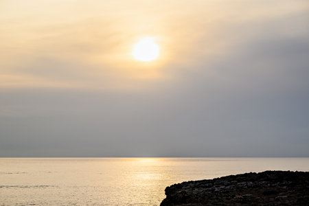 Beautiful sunset with orange sky on the beach of Menorca, Balearic Islands. Sunset, natureの写真素材