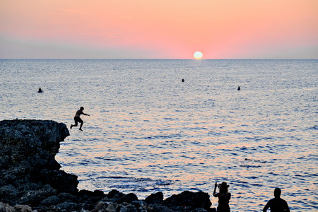 Beautiful sunset with orange sky on the beach of Menorca, Balearic Islands.の写真素材