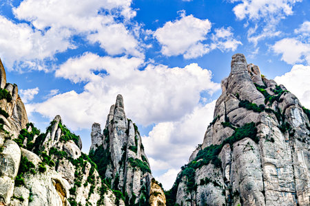 Views of the Montserrat massif, mountain in the province of Barcelona, ââCatalonia on a day with blue sky and white cloudsの写真素材