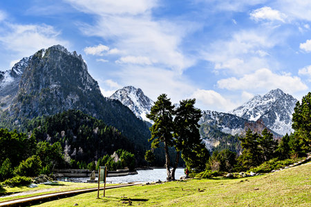 Image of Sant Maurici Lake with snow-capped mountains, in the Aigües Tortes National Park, in the Lleida Pyrenees, Catalonia, Spainの写真素材