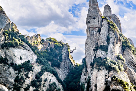 Views of the Montserrat massif, mountain in the province of Barcelona, ââCatalonia on a day with blue sky and white cloudsの写真素材