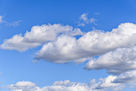 White clouds in a bright blue sky. The beauty of natureの写真素材