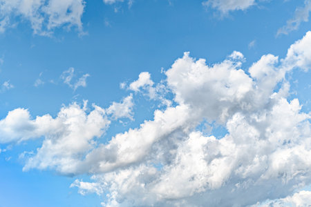 White clouds in a bright blue sky. The beauty of natureの写真素材