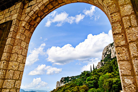 Views of the Montserrat massif, mountain in the province of Barcelona, ââCatalonia on a day with blue sky and white cloudsの写真素材