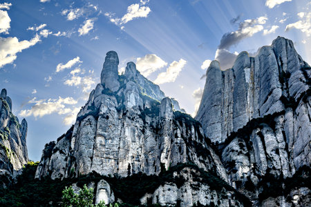 Views of the Montserrat massif, mountain in the province of Barcelona, ââCatalonia on a day with blue sky and white cloudsの写真素材