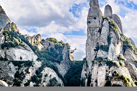 Views of the Montserrat massif, mountain in the province of Barcelona, ââCatalonia on a day with blue sky and white cloudsの写真素材