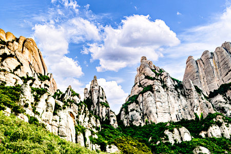 Views of the Montserrat massif, mountain in the province of Barcelona, ââCatalonia on a day with blue sky and white cloudsの写真素材