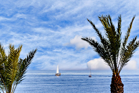 Spectacular image with calm sea and sailboat in the background on Aguadulce beach, Almeria, Spainの写真素材