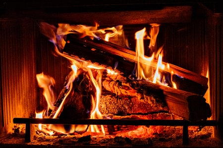 Fireplace with log fire in living room, cozy and warm homeの写真素材