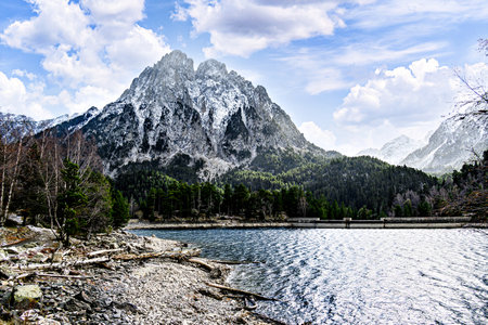 Image of Sant Maurici Lake with snow-capped mountains, in the Aigües Tortes National Park, in the Lleida Pyrenees, Catalonia, Spainの写真素材
