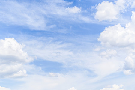 White clouds in a bright blue sky. The beauty of natureの写真素材