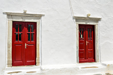 Red door, typical of a house on the island of Myconos, Cyclades, Greeceの写真素材