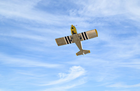 Airplane in the blue sky with white clouds, closeup of photo