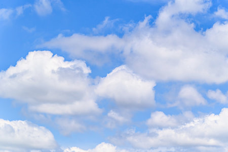 Blue sky background with white clouds. Cumulus white clouds in the blue sky.の写真素材