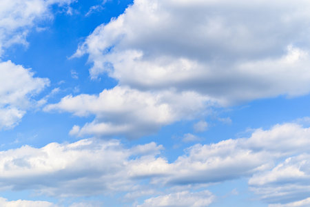 Blue sky background with tiny clouds. Cumulus white clouds in the blue sky.の写真素材