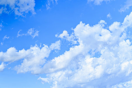Blue sky background with white clouds. Nature weather. Blue sky with white clouds. White fluffy clouds in the blue sky.の写真素材