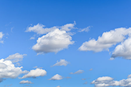 Blue sky background with white clouds. Cumulus white clouds in the blue sky.の写真素材