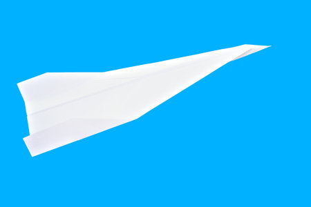 Paper plane isolated on a blue background.の写真素材