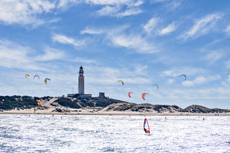 People practicing kitesurfing on the beach of Los CaÃ±os de Meca, next to the Trafalgar Lighthouse, Barbate, CÃ¡dizの写真素材