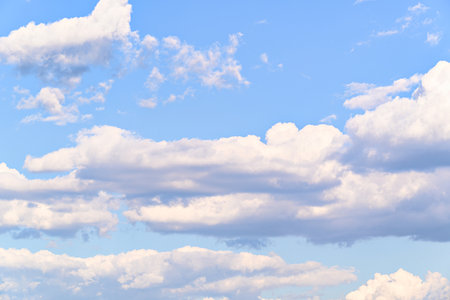 Blue sky background with tiny clouds. Cumulus white clouds in the blue sky.の写真素材