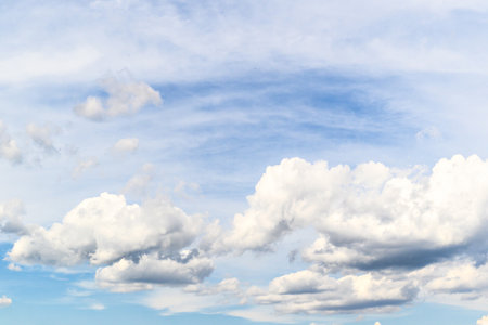 Blue sky background with tiny clouds. Cumulus white clouds in the blue sky.の写真素材